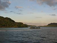 Approaching Huahine...note water rippling over coral reef in the foreground.